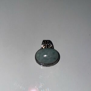 Sterling Silver and Jade Filigree Pendant
.75 inch across